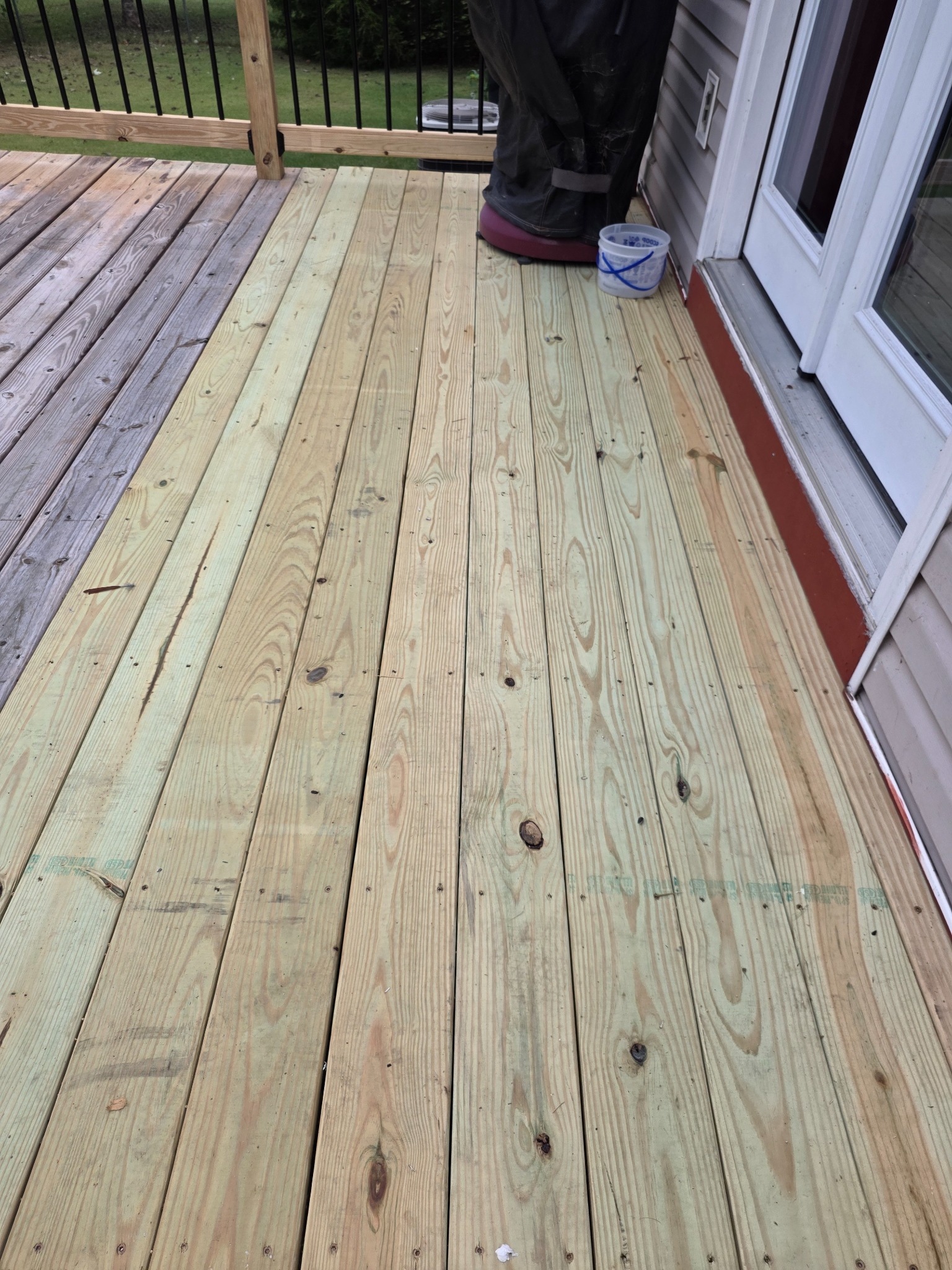 New wood decking alongside retained porch boards